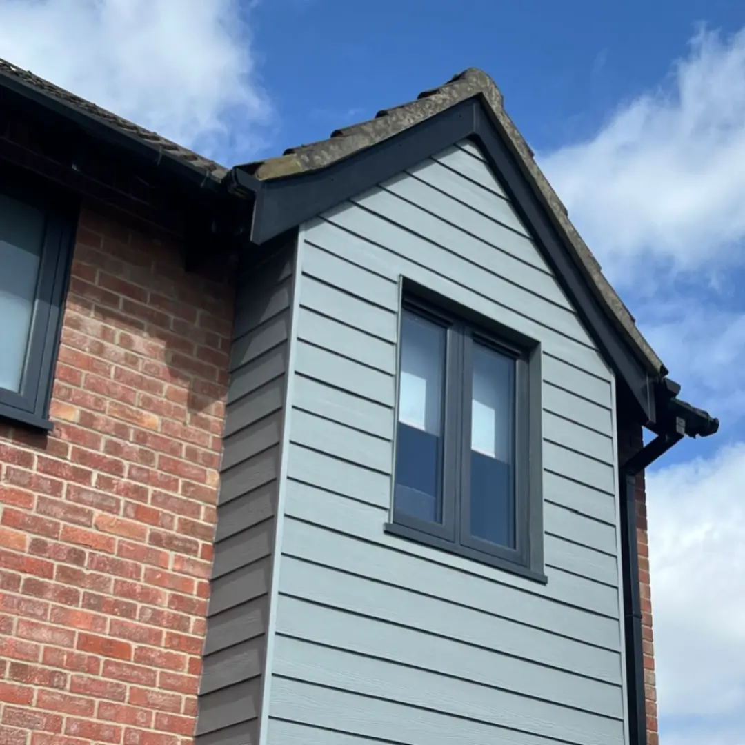 Durable, weather-resistant exterior wall cladding meticulously fitted to a residential brick gable end by Norfolk Exterior Solutions